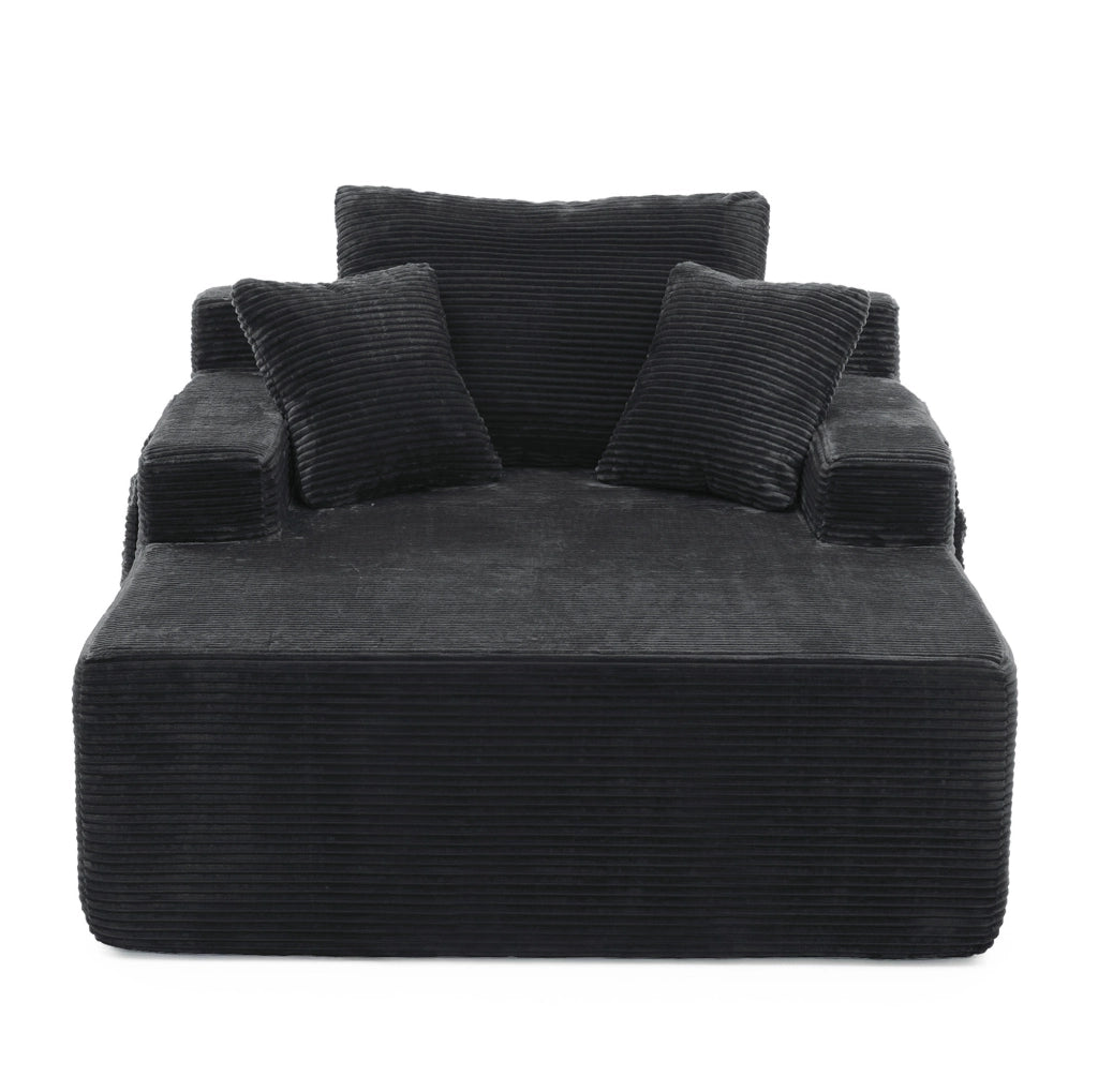 Divano compatto in corduroy nero con tasche laterali e cuscini decorativi