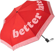 Ombrello con scritta "Better late than ugly"