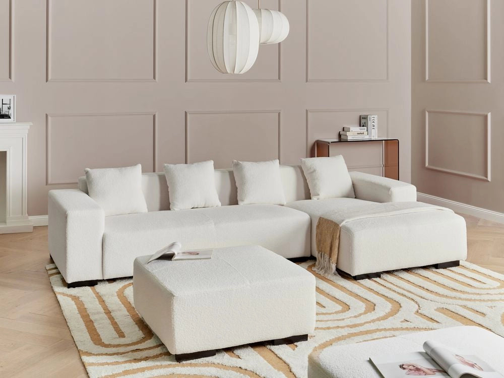 Divano angolare a L con cuscini 4 posti in tessuto bouclè bianco con ottomana versione a sinistra stile elegante moderno